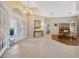 Spacious foyer with glass doors, chandelier, tile flooring, and views of dining room at 2847 Mossy Timber Trl, Valrico, FL 33596