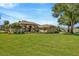 Beautifully landscaped front yard with mature trees and lush green grass at 2847 Mossy Timber Trl, Valrico, FL 33596