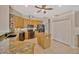 Traditional kitchen with oak cabinets, granite countertops, stainless steel appliances, and a central island at 2847 Mossy Timber Trl, Valrico, FL 33596