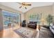 Bright living room features a sliding glass door to screened patio and pool area at 2847 Mossy Timber Trl, Valrico, FL 33596