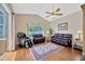 Comfortable living room with high ceilings, ceiling fan, and hardwood floors at 2847 Mossy Timber Trl, Valrico, FL 33596