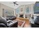 Spacious living room with fireplace, high ceilings, and views of the screened-in pool at 2847 Mossy Timber Trl, Valrico, FL 33596