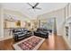 Open-concept living room with hardwood floors that connects to the kitchen and dining room at 2847 Mossy Timber Trl, Valrico, FL 33596