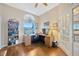 Home office featuring a large window, custom desk, and wood flooring at 2847 Mossy Timber Trl, Valrico, FL 33596