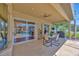 Covered patio with ceiling fan, outdoor seating, and views of the pool and backyard at 2847 Mossy Timber Trl, Valrico, FL 33596