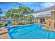 Backyard with a screened-in pool, basketball hoop and lounge chairs at 2847 Mossy Timber Trl, Valrico, FL 33596
