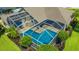 Screened in pool with clear blue water surrounded by well-manicured landscaping at 2847 Mossy Timber Trl, Valrico, FL 33596