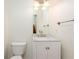 Cozy downstairs half-bath with a toilet, sink with chrome faucet, and a bright vanity light at 2876 Bayshore Trails Dr, Tampa, FL 33611