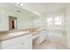 Bright bathroom with double sinks, vanity and natural light from the window with shutters at 2876 Bayshore Trails Dr, Tampa, FL 33611
