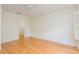 Light-filled bedroom with hardwood floors, a ceiling fan, neutral walls, and a view of a walk-in closet at 2876 Bayshore Trails Dr, Tampa, FL 33611