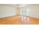 Bedroom featuring hardwood floors, ceiling fan, and French doors to a small outdoor balcony at 2876 Bayshore Trails Dr, Tampa, FL 33611