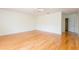 Bedroom featuring hardwood floors, ceiling fan, and access to a private hallway at 2876 Bayshore Trails Dr, Tampa, FL 33611
