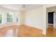 Bright bedroom featuring hardwood floors, neutral walls, bay windows, and a view into the next room at 2876 Bayshore Trails Dr, Tampa, FL 33611
