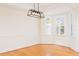 Bright dining room featuring hardwood floors, modern light fixture and a window with shutters at 2876 Bayshore Trails Dr, Tampa, FL 33611