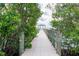 Picturesque dock extending into the water, surrounded by lush greenery, offering a serene waterfront experience at 2876 Bayshore Trails Dr, Tampa, FL 33611