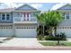 Charming townhome with a two-car garage, lovely landscaping, and a cute second-floor balcony at 2876 Bayshore Trails Dr, Tampa, FL 33611