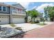 Charming townhouse exterior with a private balcony, two-car garage, and well-manicured landscaping at 2876 Bayshore Trails Dr, Tampa, FL 33611