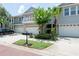 Townhouse exterior boasting a private balcony, a two-car garage, and lush landscaping in a tranquil setting at 2876 Bayshore Trails Dr, Tampa, FL 33611