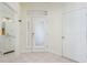 Bright foyer with tile flooring, a white door, and a view of the downstairs half-bath and stairs at 2876 Bayshore Trails Dr, Tampa, FL 33611