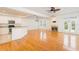 Bright living room with hardwood floors, a fireplace, ceiling fan and an open-concept kitchen at 2876 Bayshore Trails Dr, Tampa, FL 33611