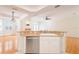 Kitchen counter overlooking the living room with a fireplace, hardwood floors, and plantation shutters at 2876 Bayshore Trails Dr, Tampa, FL 33611