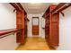 Spacious walk-in closet featuring custom wood shelving and drawers for optimal organization and plenty of storage space at 2876 Bayshore Trails Dr, Tampa, FL 33611