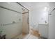 Bathroom featuring a glass door shower with seat, tiled floor, and a white single sink vanity at 3053 Pointeview Dr, Tampa, FL 33611