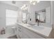 Bright bathroom featuring a double sink vanity, large mirrors, and a separate toilet area at 3053 Pointeview Dr, Tampa, FL 33611