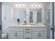 Spacious bathroom featuring a double sink vanity, large mirrors, and a glass-enclosed shower at 3053 Pointeview Dr, Tampa, FL 33611