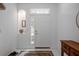 Bright foyer featuring tile floors, a decorative alcove, and classic decor at 3053 Pointeview Dr, Tampa, FL 33611
