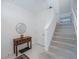 Bright foyer featuring tile floors, stairs, and a wooden console table at 3053 Pointeview Dr, Tampa, FL 33611