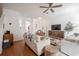 Spacious living room featuring hardwood floors, a ceiling fan and stylish decor at 3053 Pointeview Dr, Tampa, FL 33611