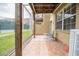 Comfortable screened in patio with brick floors, comfortable seating, and exterior views at 3053 Pointeview Dr, Tampa, FL 33611