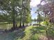 Community pond with a bench, sidewalk, and plenty of shade at 3053 Pointeview Dr, Tampa, FL 33611