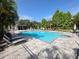 Community pool with plenty of seating and a hot tub at 3053 Pointeview Dr, Tampa, FL 33611