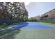 Community tennis court with seating and a tall privacy fence at 3053 Pointeview Dr, Tampa, FL 33611