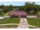 Aerial view of a single-Gathering home with a well-kept lawn, a long drive, and a fenced-in backyard at 3509 King George Ln, Seffner, FL 33584
