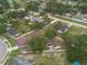 An aerial image showing multiple homes and green lawns in a residential neighborhood with mature trees at 3509 King George Ln, Seffner, FL 33584