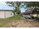 Backyard with car port containing boat, offering convenient storage and protection from the elements, with lawn space at 3509 King George Ln, Seffner, FL 33584