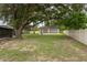 Expansive backyard with mature trees and detached garage, offering ample space for outdoor activities at 3509 King George Ln, Seffner, FL 33584