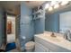 Bathroom with a mirror, sink, toilet, shower with a shower curtain, and shelving at 3509 King George Ln, Seffner, FL 33584