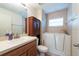 Well-lit bathroom with a walk-in tub, white cabinets, and a sleek vanity, blending accessibility with style at 3509 King George Ln, Seffner, FL 33584