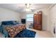 Well-lit bedroom with ceiling fan and window, featuring wardrobe closet at 3509 King George Ln, Seffner, FL 33584