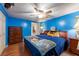 Bright bedroom featuring a ceiling fan, a bed, and a wooden floor at 3509 King George Ln, Seffner, FL 33584