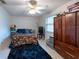 Comfortable bedroom with a ceiling fan, area rug, and a wooden dresser at 3509 King George Ln, Seffner, FL 33584