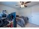 Bedroom features a ceiling fan, desk, computer, and a bed with an NFL blanket at 3509 King George Ln, Seffner, FL 33584