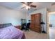 Bedroom features a ceiling fan, tile floors, and a decorative cabinet, providing a cozy, functional space at 3509 King George Ln, Seffner, FL 33584