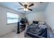 Bedroom with a ceiling fan, desk, window, and a bed with an NFL blanket at 3509 King George Ln, Seffner, FL 33584