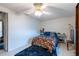 Bedroom with tile floor, ceiling fan, and light blue end tables at 3509 King George Ln, Seffner, FL 33584