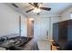 Bright bedroom with closet, TV, ceiling fan, and a glimpse into the hallway at 3509 King George Ln, Seffner, FL 33584